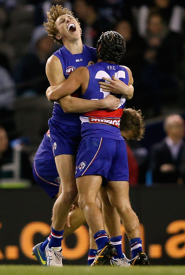 AFL 2015 Rd 17 - Western Bulldogs v Collingwood MELBOURNE, AUSTRALIA - JULY 26: Bailey Dale (left) and Caleb Daniel of the Bulldogs celebrate a goal during the 2015 AFL round 17 match between the Western Bulldogs and the Collingwood Magpies at Etihad Stadium, Melbourne, Australia on July 26, 2015. (Photo by Adam Trafford/AFL Media)